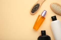 A lot of different cosmetic products for hair care on beige